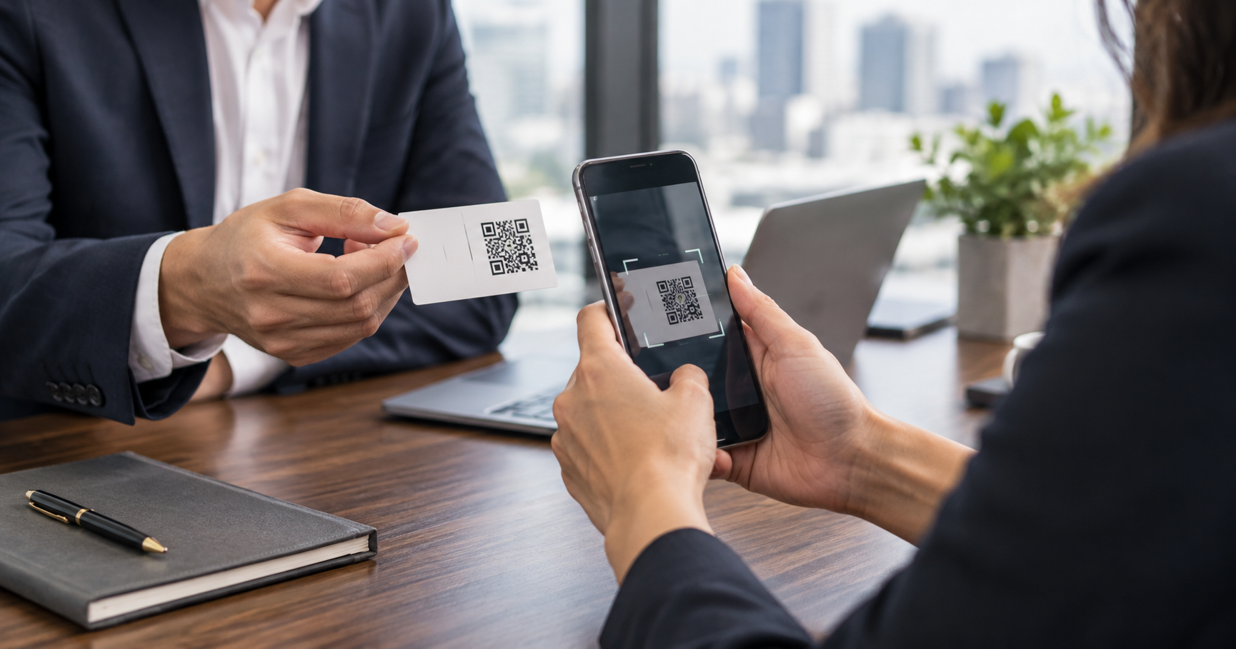 Smartphone scanning a QR business card during a networking meeting